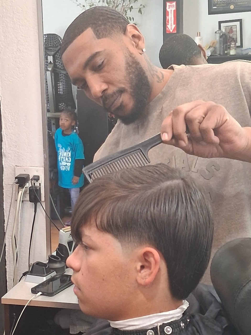 Curly and coily texture cut by Style Masters Barbershop