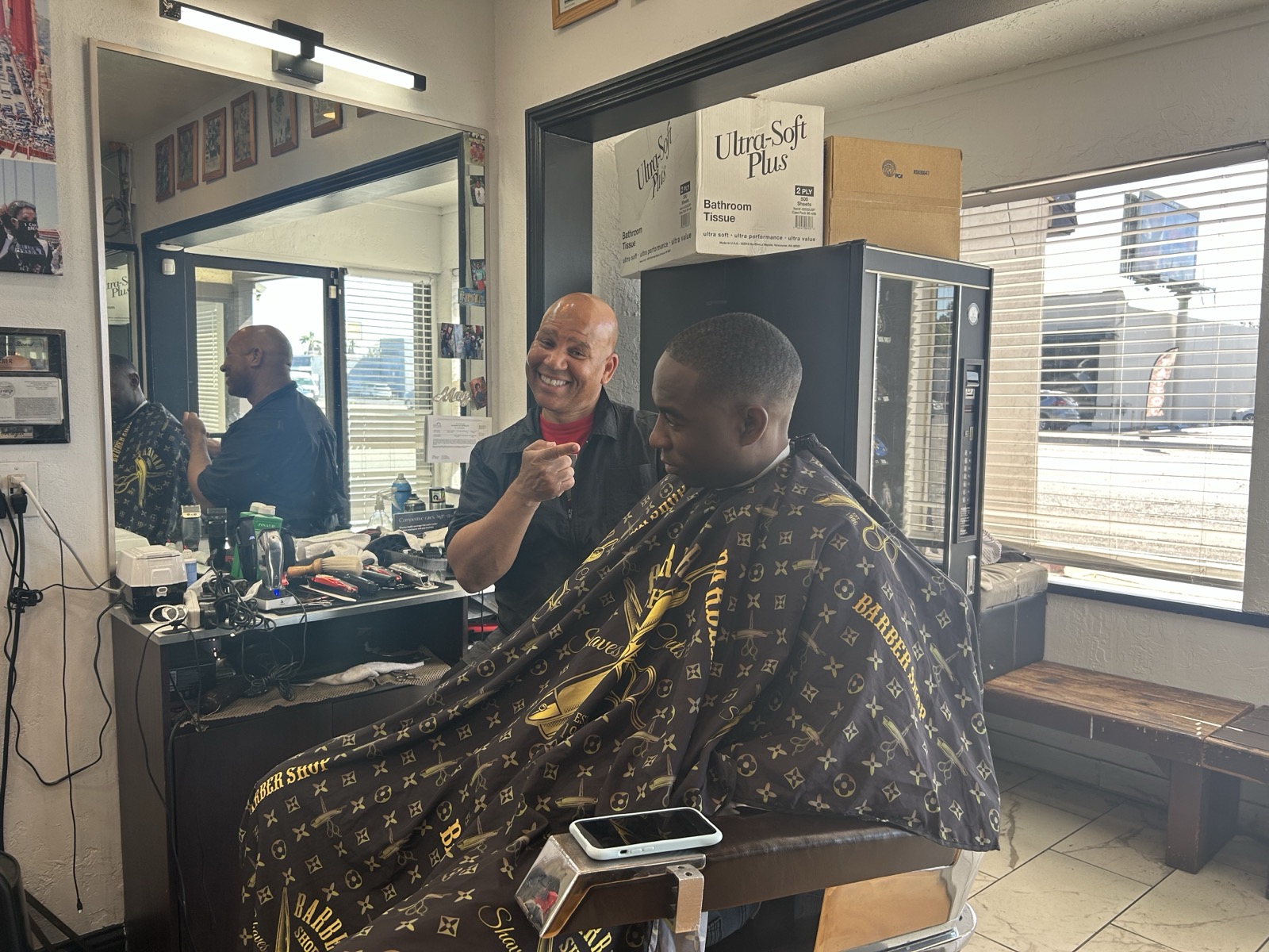 Magic laughing with a client mid-cut